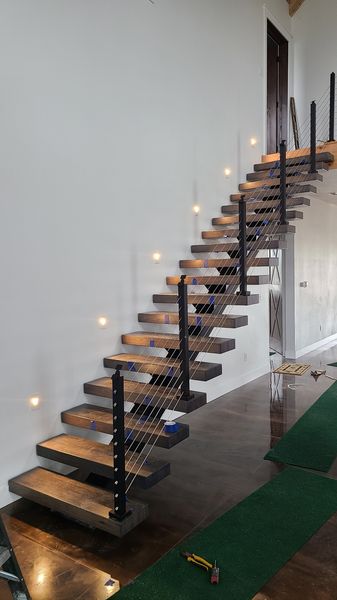 Floating staircase with step lights in the wall