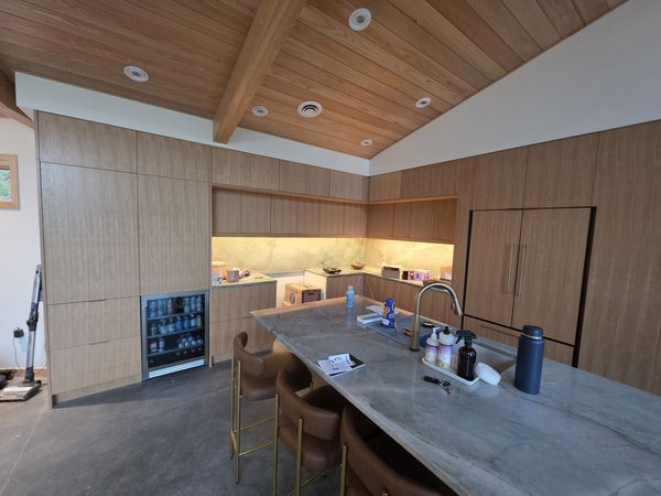 Wood kitchen with under-cabinet lighting and recessed lights in a wood ceiling
